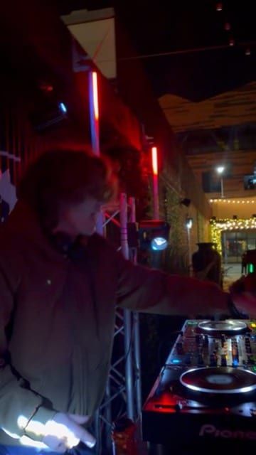 The DJ lit red beside the decks.