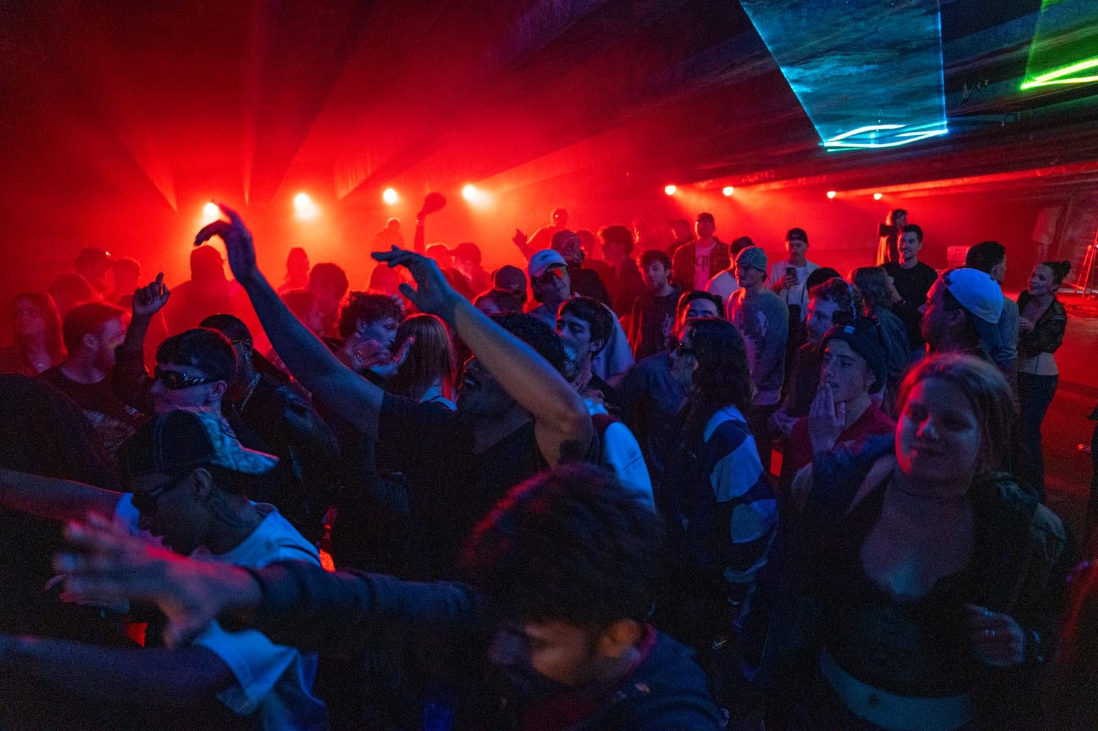The DJ booth from the side, light panels glowing behind.